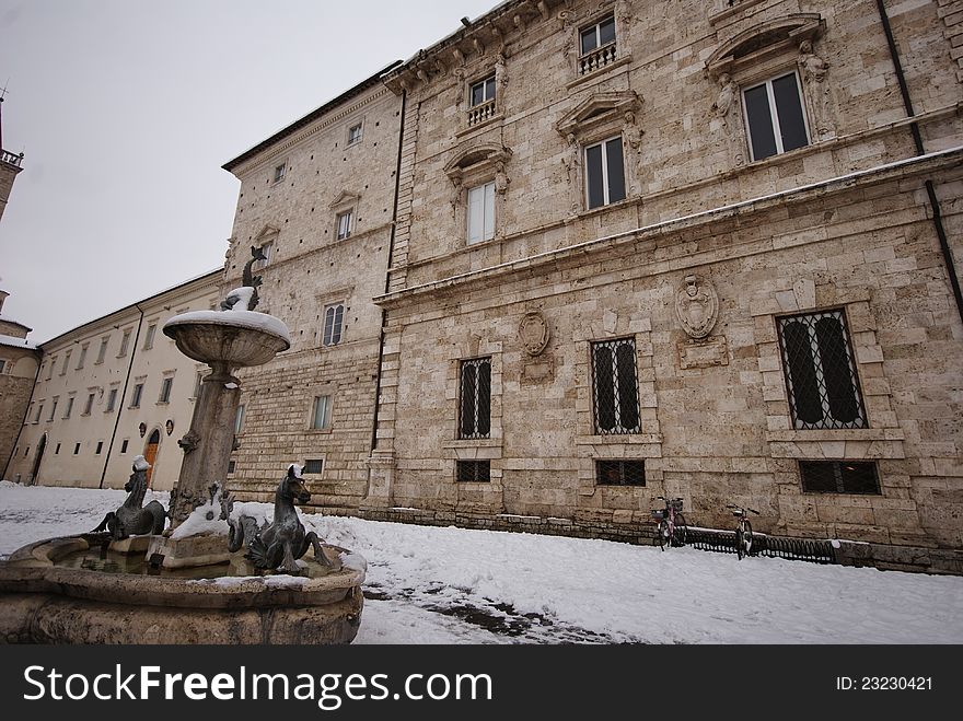Month of february in Ascoli Piceno during a snow day and view over a part of the important square of Arringo with one of the fountains and the town hall facade. Month of february in Ascoli Piceno during a snow day and view over a part of the important square of Arringo with one of the fountains and the town hall facade