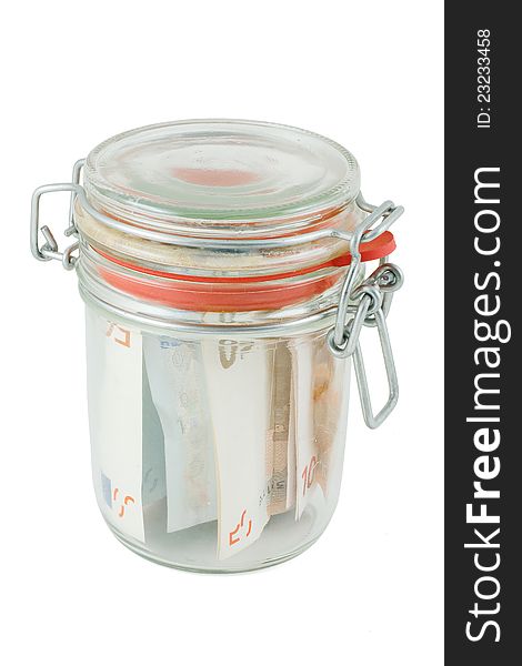 Glass jar with the money isolated on white background