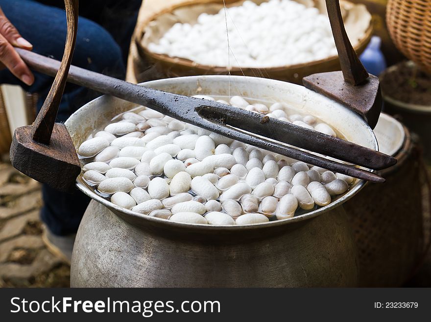 Boiling cocoon in a pot to prepare a cocoon silk.