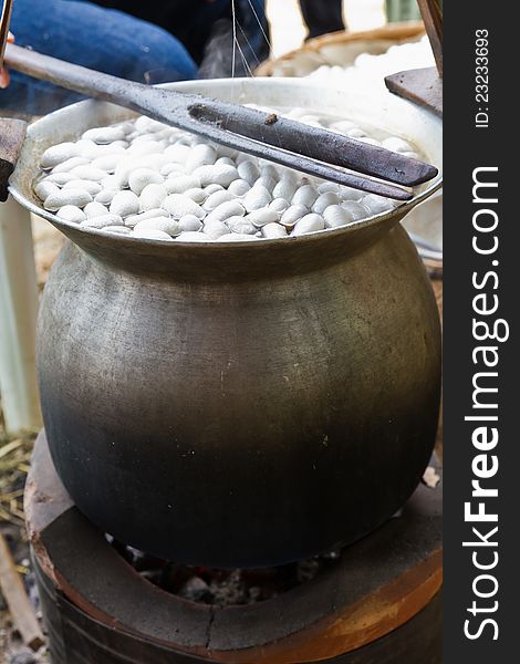 Boiling cocoon in a pot to prepare a cocoon silk.