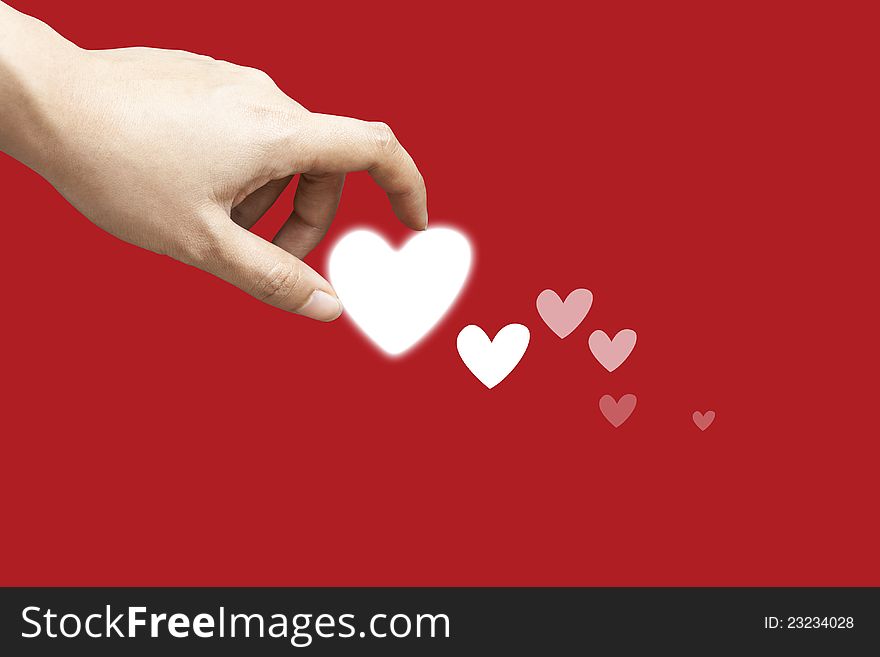 Hand holding the heart on red background. Hand holding the heart on red background.