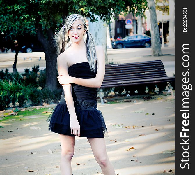 Beautiful and fashion girl with pigtails in the park