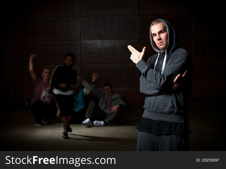 Young men posing with hip hop dancers on the background. Young men posing with hip hop dancers on the background