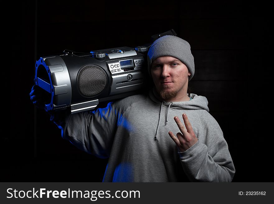 Young man, a dancer, posing with vintage boombox. Young man, a dancer, posing with vintage boombox