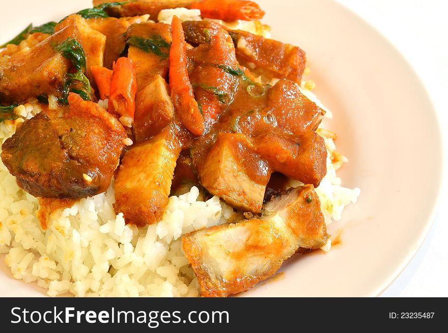 Stir fried crispy pork with red curry paste and rice. Stir fried crispy pork with red curry paste and rice