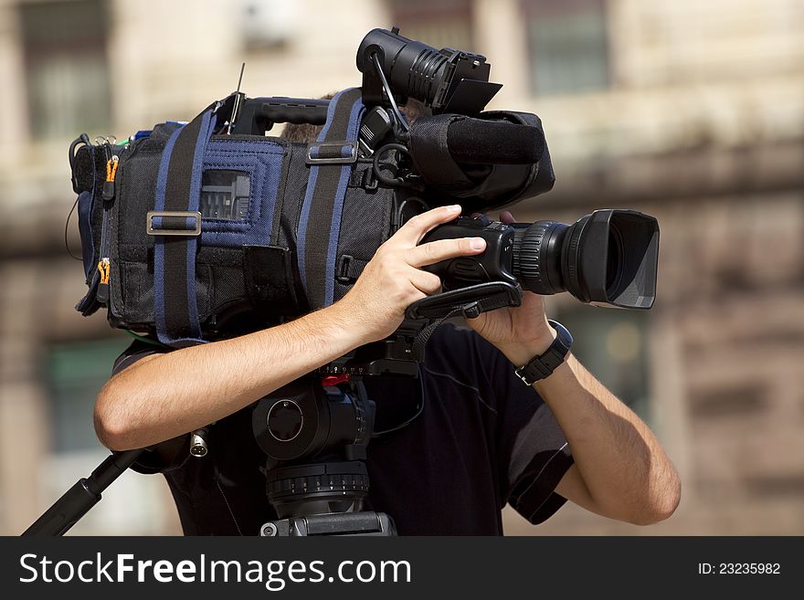 Cameraman working in the street. Cameraman working in the street