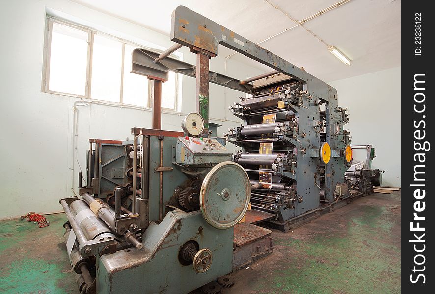 Interior of a factory, old machine for printing. Interior of a factory, old machine for printing.