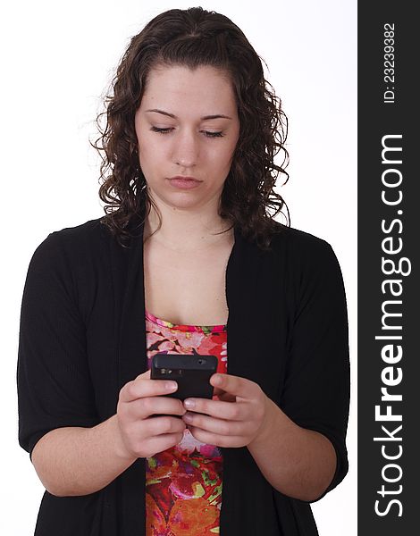 A young woman texting on smartphone with serious expression. A young woman texting on smartphone with serious expression