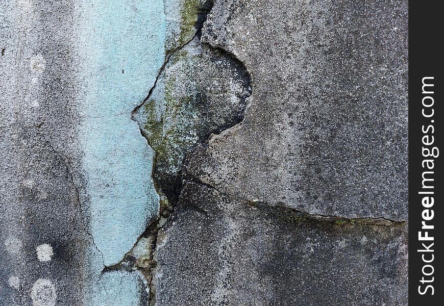 Closeup view of old cracked wall with blue stripe due to running water. Closeup view of old cracked wall with blue stripe due to running water