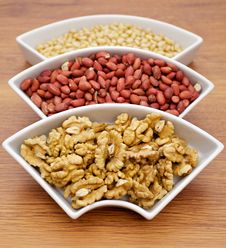 White Plats With Walnuts, Peanut And Pine Nut Stock Photo