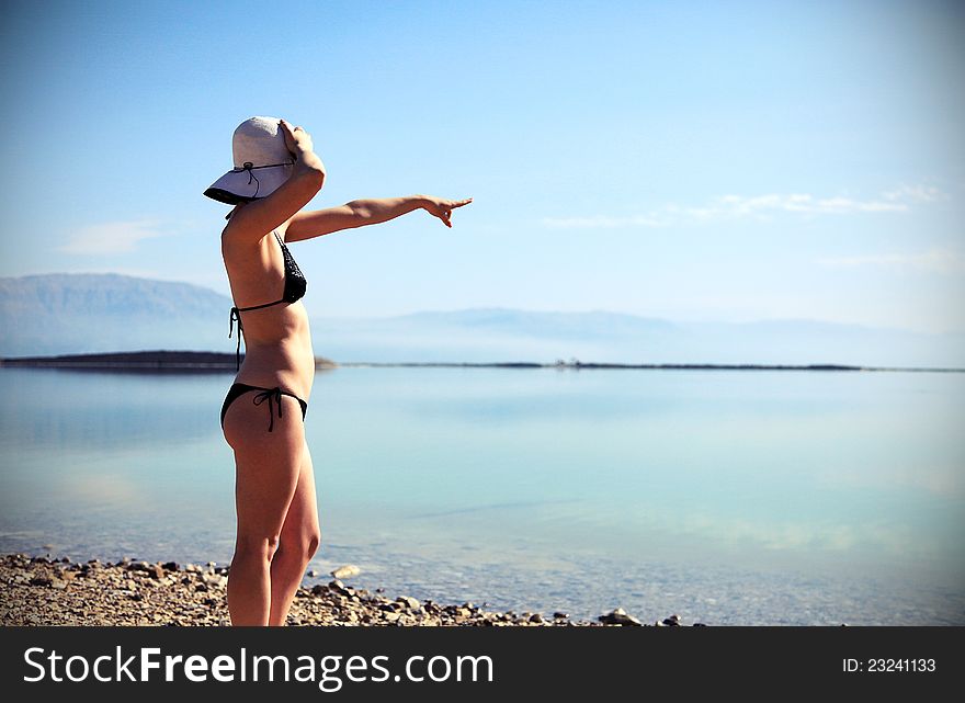 Girl sunbathing on the beach with warm summer day. Girl sunbathing on the beach with warm summer day