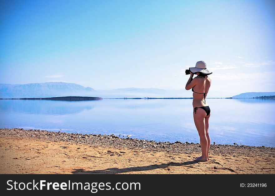 Girl sunbathing on the beach with warm summer day. Girl sunbathing on the beach with warm summer day