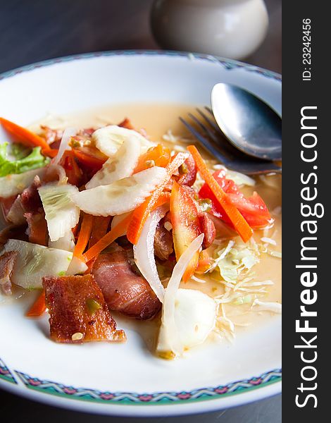 Thai style bacon salad on white plate. Thai style bacon salad on white plate
