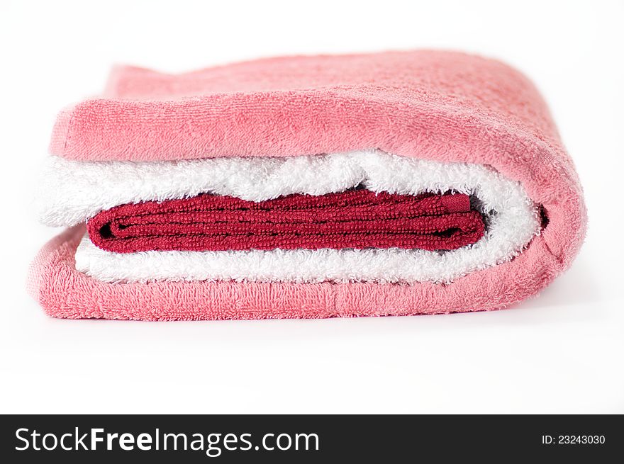 White, red and pink Terry towels on white background