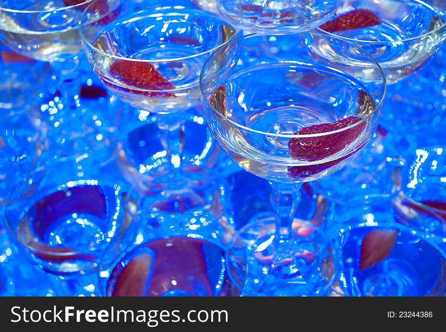 Champagne glasses detail photo, shallow depth of field, blue artificial light