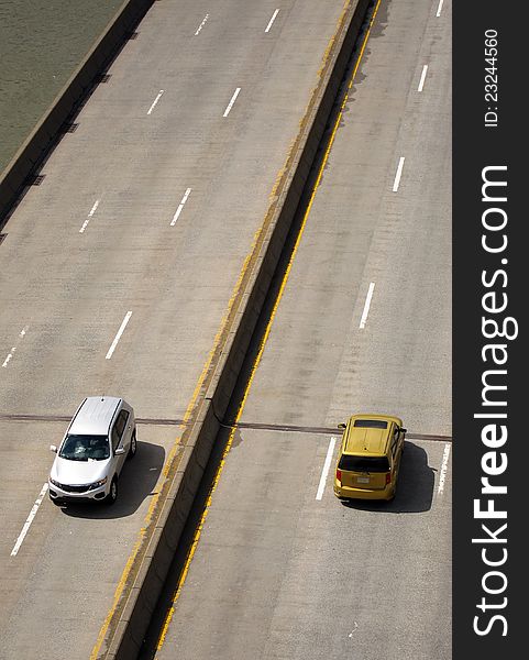 Only two cars on an empty freeway, photo taken in New York. vertical composition. Only two cars on an empty freeway, photo taken in New York. vertical composition