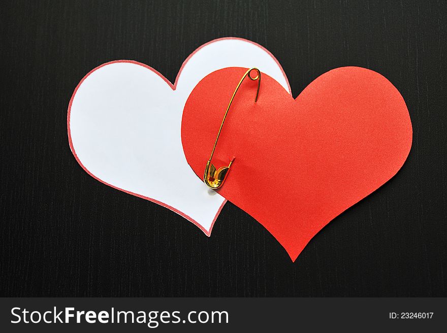 Two pin hearts on dark background. Two pin hearts on dark background