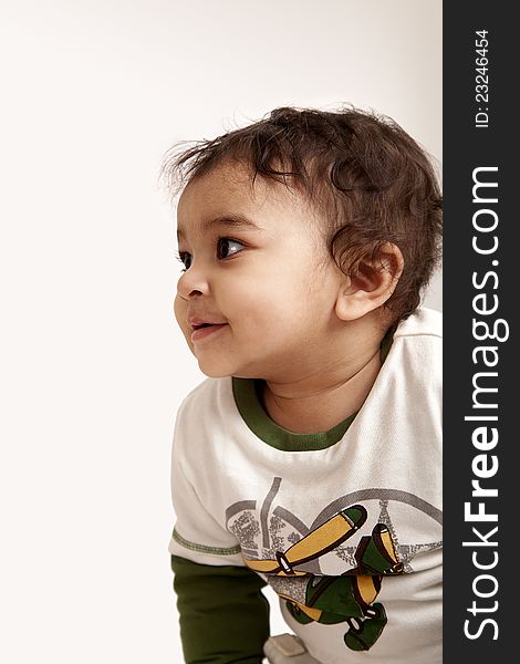 Adorable Indian baby laughing a over white background