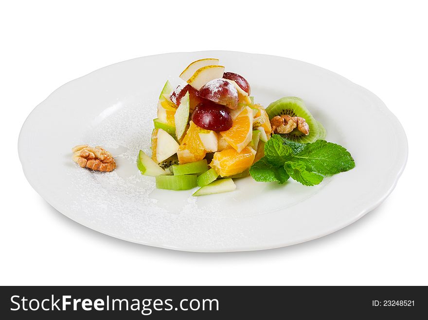 Fruit salad (kiwi, orange, grapes) on plate