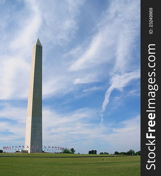 The Washington Monument with light, wispy clouds behind.