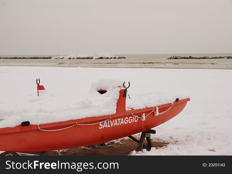 Rescue Boat On The Beach Covered With Snow