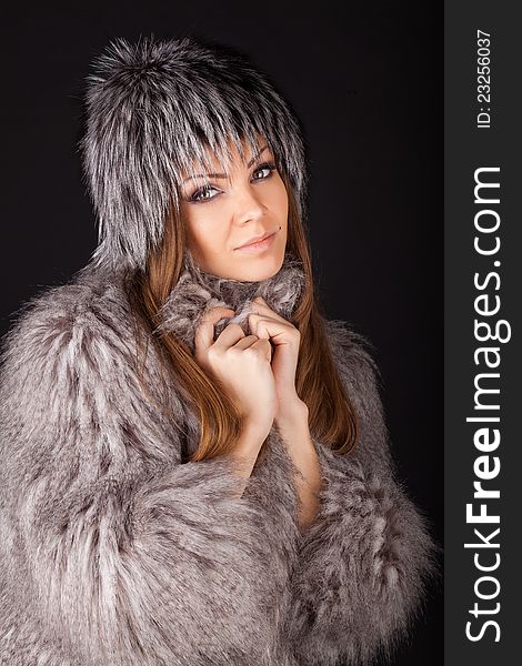 Portrait of a beautiful smiling woman in furs