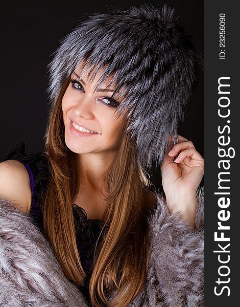 Portrait of a beautiful smiling woman in furs