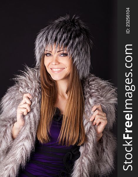 Portrait of a beautiful smiling woman in furs