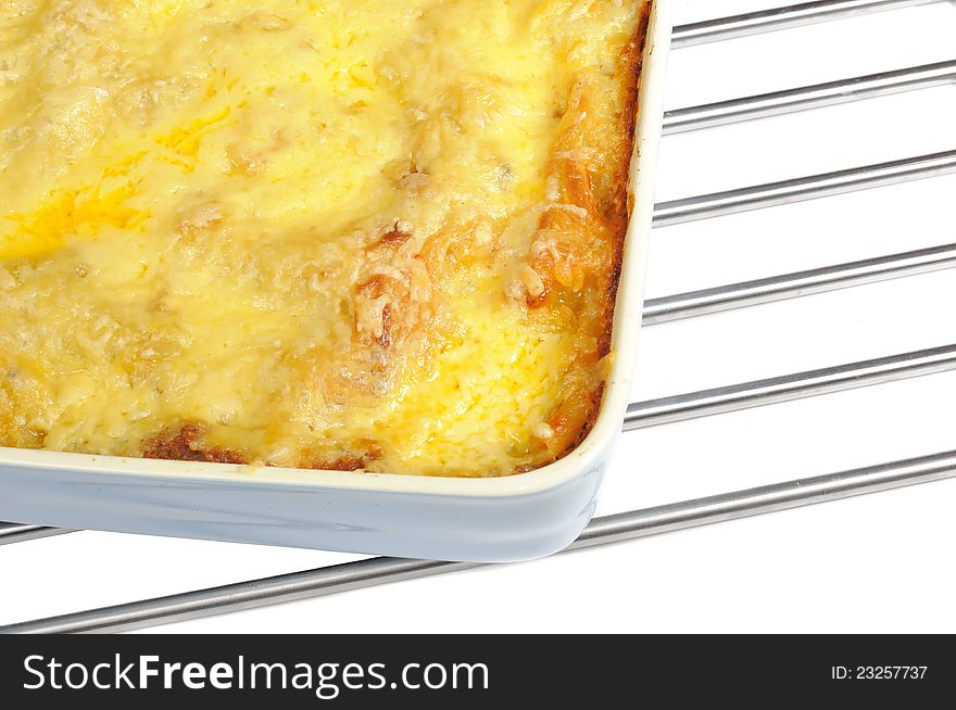 Lasagna topped with parmesan cheese in a ceramic baking dish. Lasagna topped with parmesan cheese in a ceramic baking dish