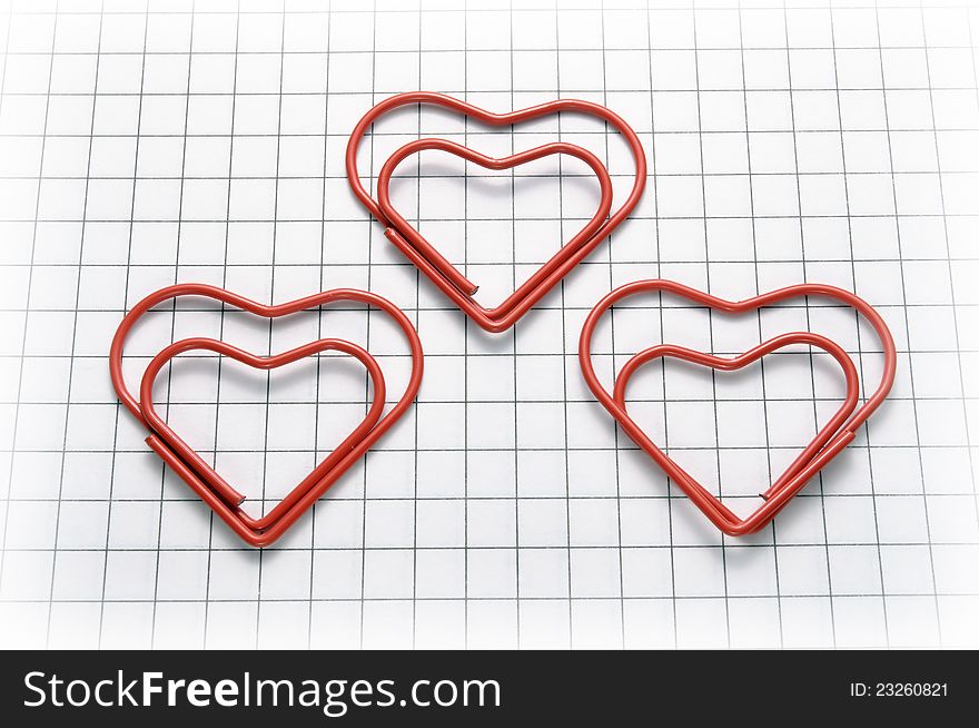 Closeup of heart shaped red paper clips. Closeup of heart shaped red paper clips