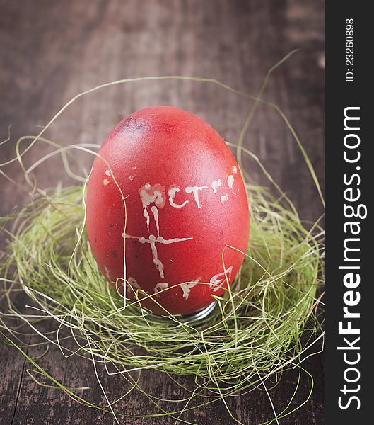 Red easter egg on wooden plank