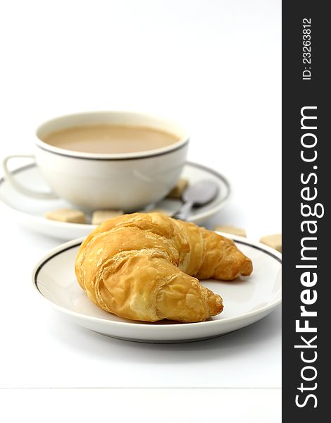 Croissant and coffee on white background