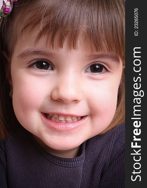 Portrait Of A Beautiful Little Girl In A Purple Mo