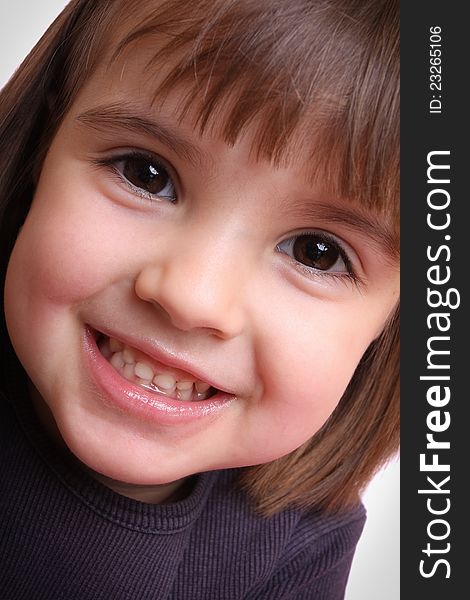 Portrait of a beautiful little girl in a purple mo