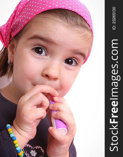 Portrait of a beautiful little girl in a purple mo