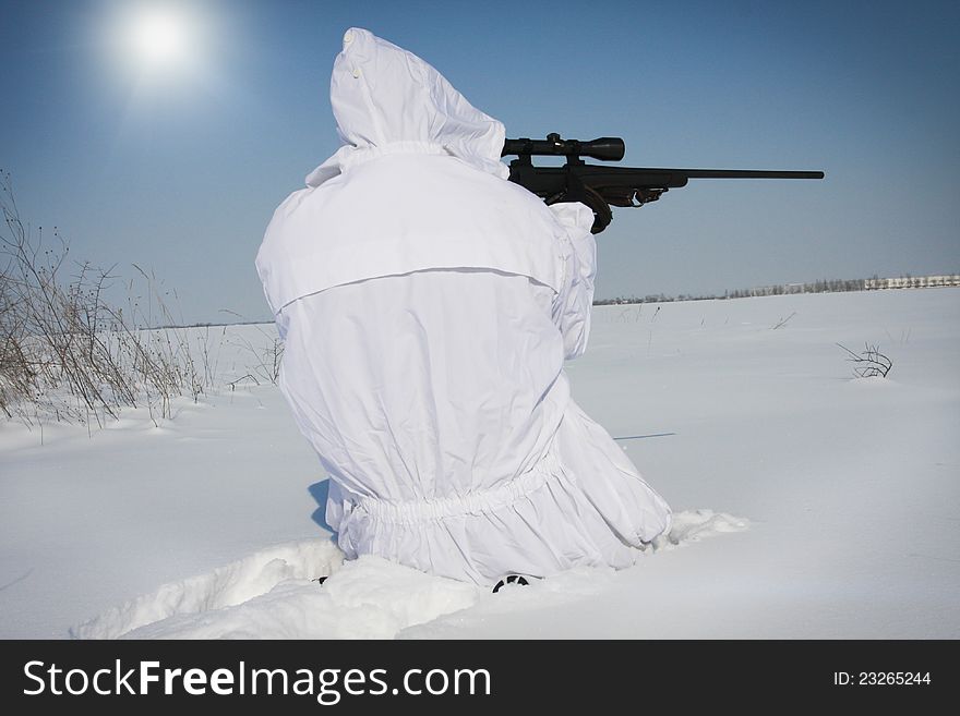 Man preparing to take a long shot during a winter blizzard. Man preparing to take a long shot during a winter blizzard