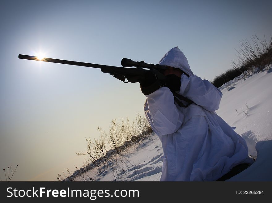 Man preparing to take a long shot during a winter blizzard. Man preparing to take a long shot during a winter blizzard