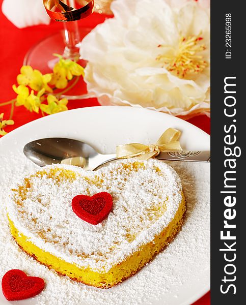 Sweet cake in heart shape on a plate