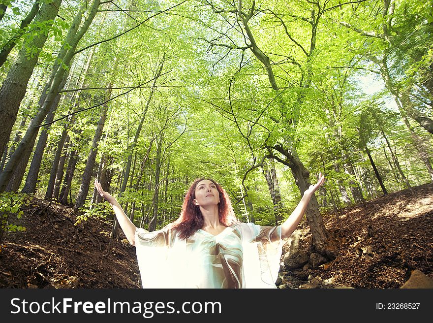 Forest girl in front of trees