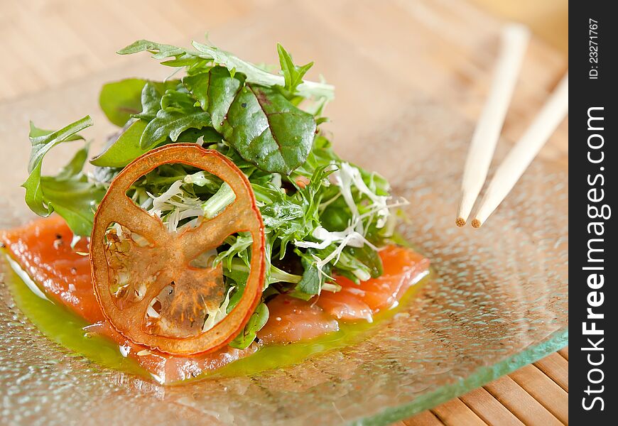 Smoked Salmon salad, served on glass plate