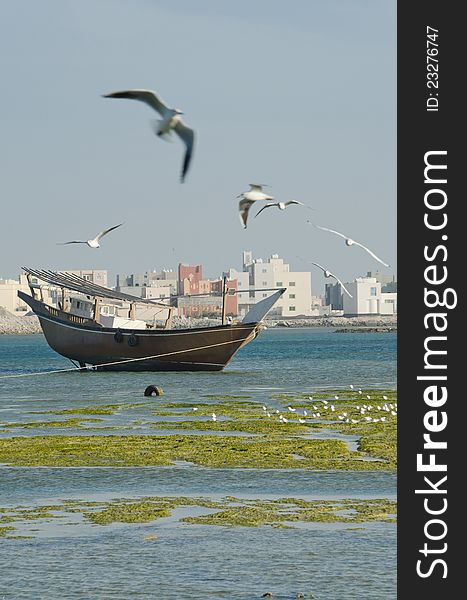 Old fishing boat on the sea and seagulls