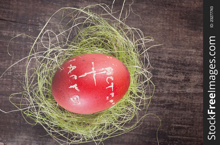 Red easter egg on wooden plank