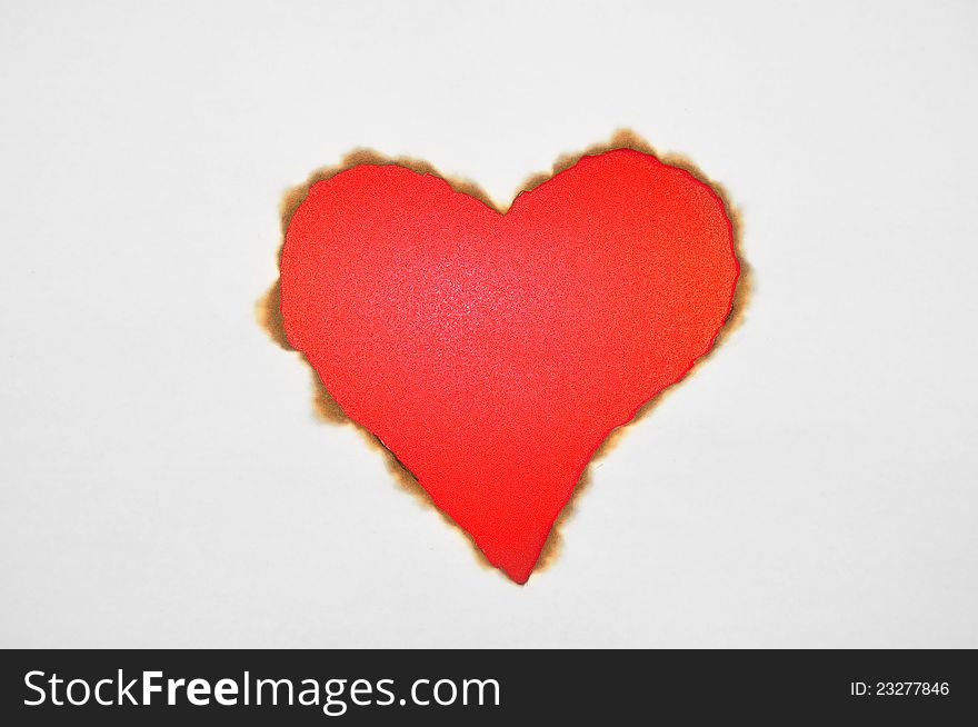 Valentines red heart burned in paper. Valentines red heart burned in paper