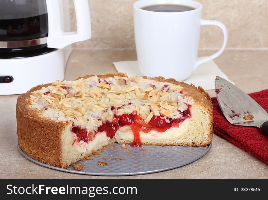 Cherry cream cheese coffee cake on a kitchen counter