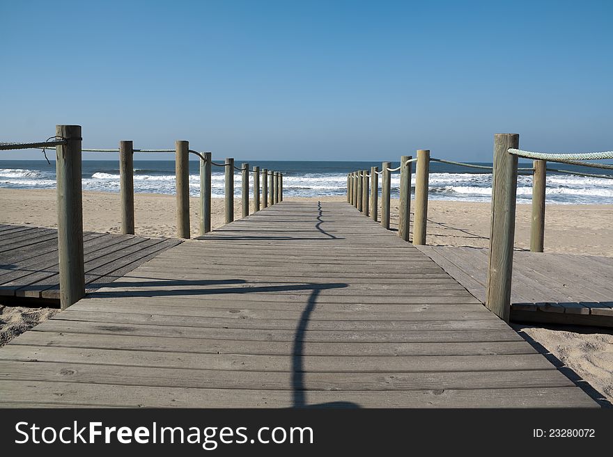 Wooden bridge leading to the sandy shore. Wooden bridge leading to the sandy shore