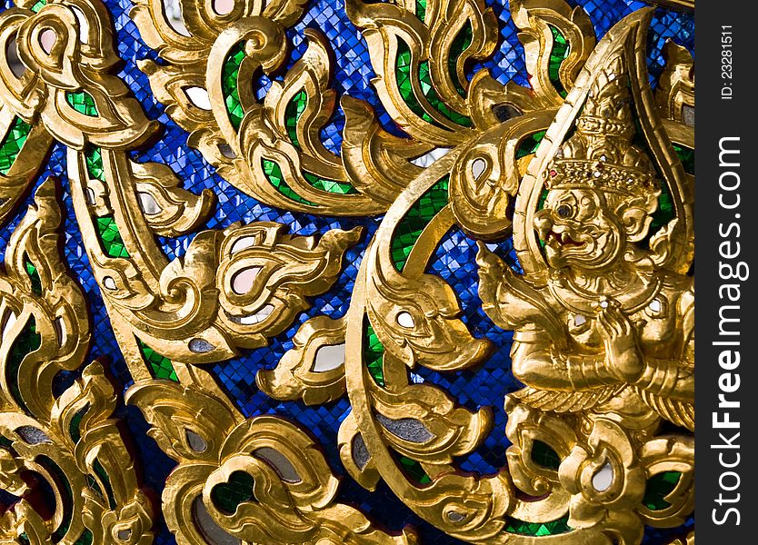 Wood carvings is a form of Thai art and painted black paint over the designs with gold