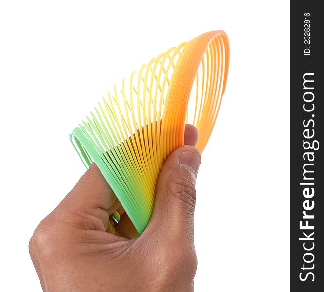 Hand Holding A Colorful Slinky Toy. Hand Holding A Colorful Slinky Toy