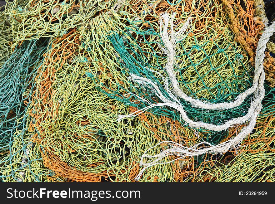 Tangled fishing nets on the old wooden pier. Tangled fishing nets on the old wooden pier.