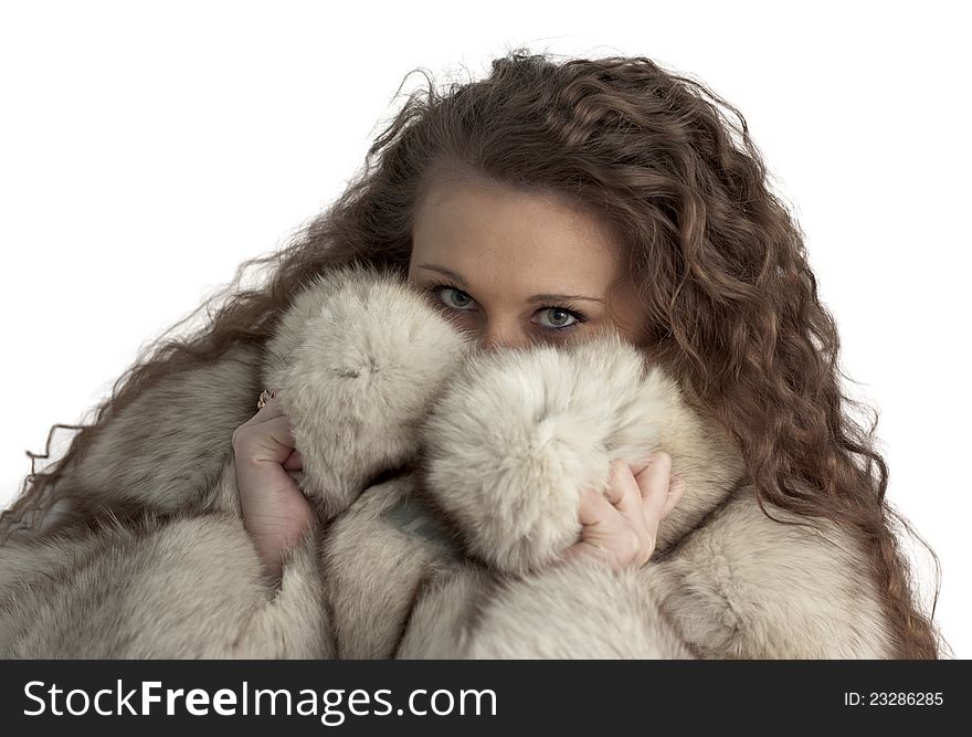 A young girl hiding in the fur. A young girl hiding in the fur