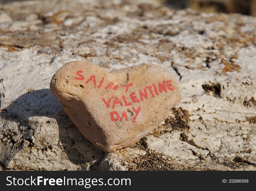 Closeup shot over a stone heart for the day of Saint Valentine, annual commemoration held on February 14 celebrating love and affection between intimate companions. Closeup shot over a stone heart for the day of Saint Valentine, annual commemoration held on February 14 celebrating love and affection between intimate companions